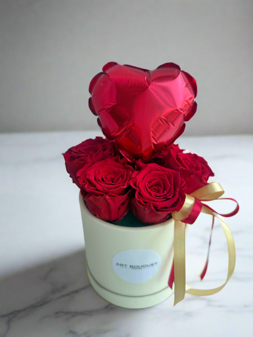 Red roses in the round box with a heart-shaped balloon. Free delivery in the Montreal area. Delivery until might night