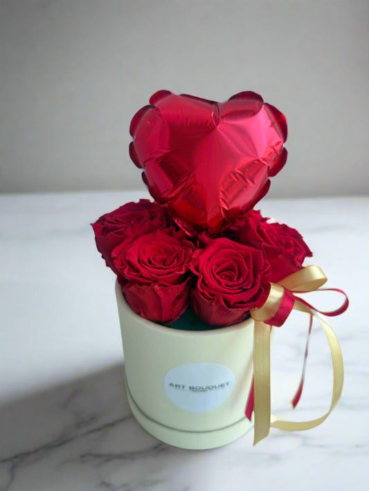 Red roses in the round box with a heart-shaped balloon. Free delivery in the Montreal area. Delivery until might night