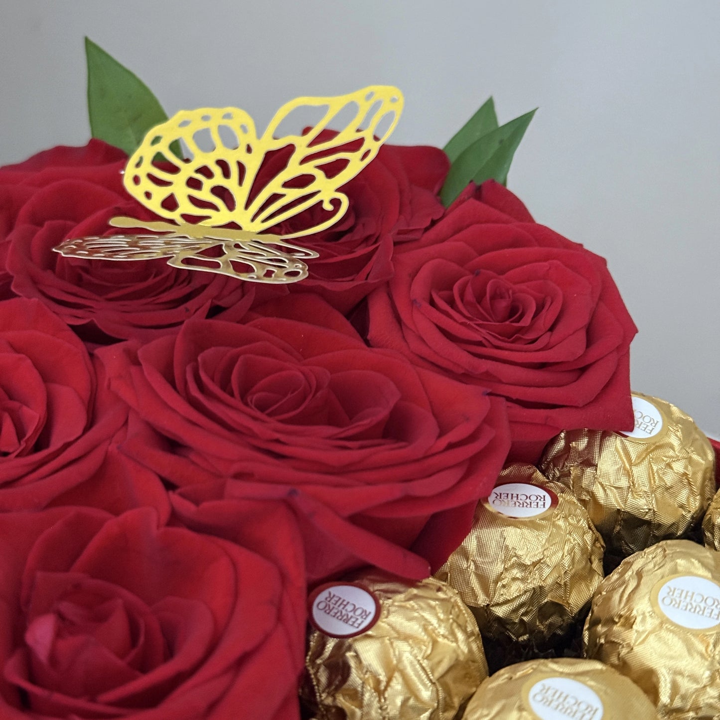 Red roses with a gold butterfly and Ferrero Rocher chocolates. Perfect gift for Valentines day in mtl. Same-day delivery Montreal