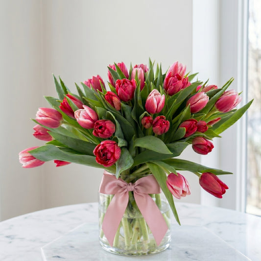 TULIP BLUSH — 21 pink and red premium tulips in a glass vase with pink satin bow, by ART BOUQUET Montreal