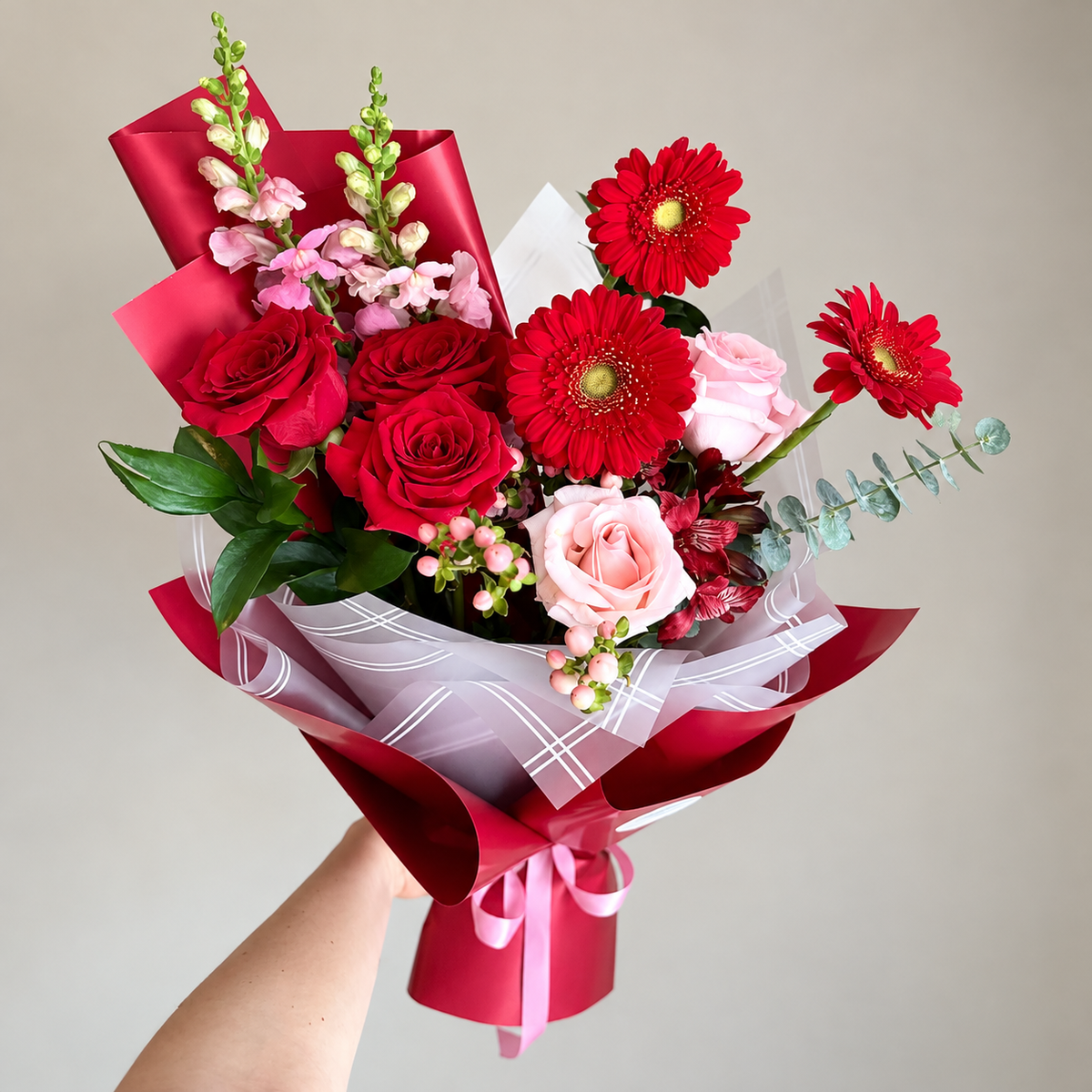 CHERRY CRUSH — red roses, red gerbera daisies and pink snapdragons bouquet in cherry-red wrap, flower delivery Montreal