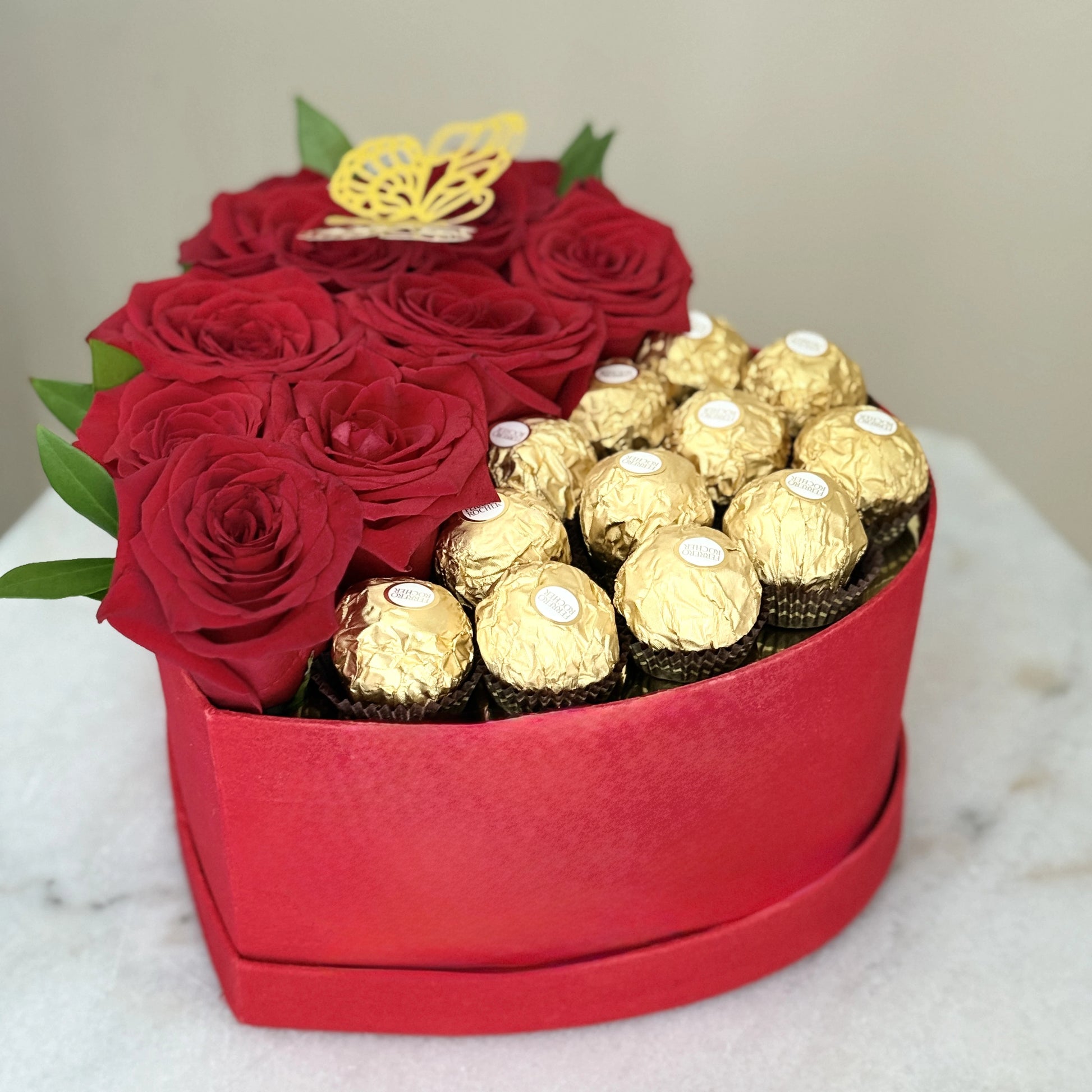 Heart-shaped box with red roses and gold Ferrero Rocher chocolates