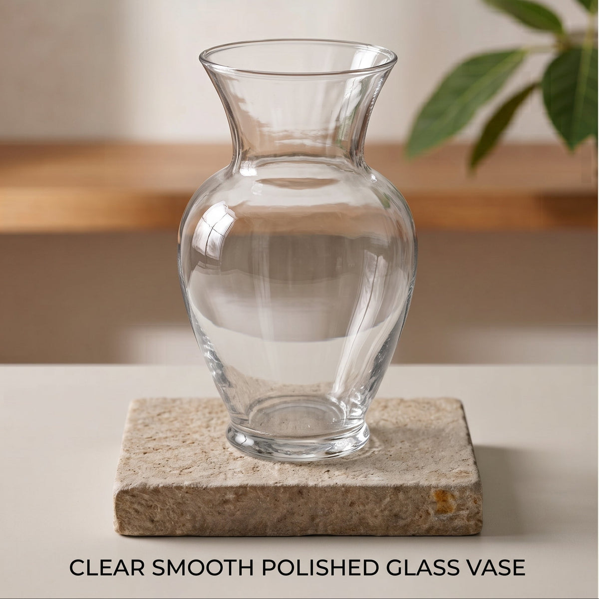 A clear smooth polished glass vase with a flared neck and rounded body, displayed on a square stone coaster with text reading 'CLEAR SMOOTH POLISHED GLASS VASE' at the bottom.