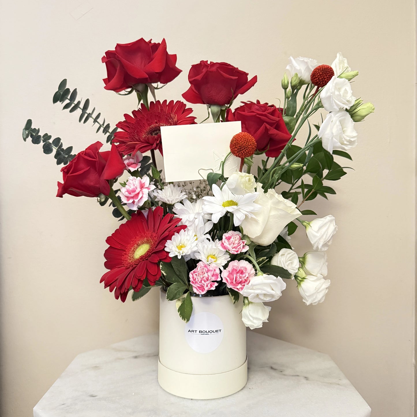Sweet, charming, and utterly delightful. This arrangement blends passionate red flowers with creamy white and soft pink carnations. It's an instant mood-booster for birthdays, congratulations, or just because